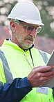 Tablet, man and scroll on construction site for architect, management and property development. Tech, reading and mature civil engineer with inspection for maintenance safety, repairs or renovation