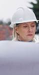 Architect, walking and woman with blueprint on construction site, inspection or property development.  Outdoor, civil engineering and mature person with floor plan, quality assurance and renovation