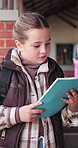 Reading, book and learning with child in school hallway for education, knowledge and academy. Study, literacy development and growth with student in corridor of campus for scholarship and project