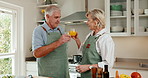 Toast, cooking and senior couple in home kitchen with juice, bonding or love in marriage. Happy, food and cheers for health and people with celebration, anniversary or drink in house for retirement