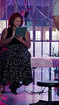 Client, tablet and woman in tattoo parlor with internet for ink design, choice or browsing for inspiration. Technology, scroll and person at shop with art blog, style decision and neon lights