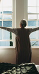 Back, old woman and open curtains in bedroom for sunshine, wellness and wake up in home. Senior person, window and thinking in house for morning routine, mindset and reflection or calm in retirement