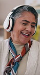 Mature, happy and dancing to music on headphones with positive attitude, energy and happiness. Excited person, technology and listen to audio in living room for playlist, subscription and internet