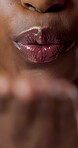 Blowing, kiss and mouth with lip gloss, closeup and smile with cosmetic transformation and hydration. Beauty, makeup and happy person with glow, wellness and self care for healthy skin or shine