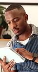 Barista, planning and man with tablet in cafe for ticket management, online order or inventory. Black person, small business or waiter typing on restaurant app for POS system, menu update or schedule
