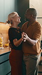 Laughing, couple and dancing in kitchen, love and bonding with partner on anniversary or special day. Mature people, celebration and rhythm with spouse, spinning and relationship commitment in house
