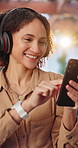 Happy, phone and woman with headphones in home for good mood, streaming and music on mobile app. Dance, smile and person with rhythm, groove and listening to radio, album and track on weekend break