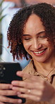 Smile, woman and relax at house with phone, social media and browsing website for comedy video. Happy, African person and laugh in home with mobile, reading funny meme and streaming for weekend break