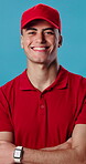 Arms crossed, face and laughing with delivery man in studio for distribution or logistics. Confidence, funny and supply chain with happy courier on blue background for ecommerce or shipping service