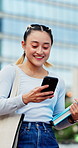 Woman, walk and college student in city with phone, book and laugh for funny text message on commute. Happy, Japanese person and outdoor in town with tech, internet humor and travel to university.