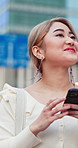 Woman, phone and walking in city with travel, texting and sightseeing for social media. Adventure, exploring and happy Asian person with mobile app, communication and technology on trip in Japan