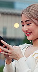 Asian woman, phone and typing outdoor with internet connection, city news or social media post. Bokeh, app and happy person search on website, network or digital platform for communication in Tokyo