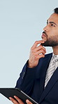 Thinking, business and man in studio with tablet, research or schedule viewing for real estate. Space, realtor and reflection with digital, listing information and auction property on blue background