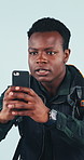 Picture, man and hiker with phone for travel memory, social media post and online vlog. Trekking, studio and black person with mobile for photography, status update and holiday on blue background