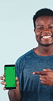 Face, fitness and man with phone for green screen in studio, marketing or sale on background. Mobile, happy black person or point at display for mockup space, exercise app or gym subscription ad