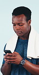 Fitness, app and man with phone in studio for online communication, thinking or text message. Mobile, black person and athlete typing, response idea and exercise info with health on background
