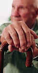 Hands, thinking and walking stick with old man in retirement home for insight or inspiration. Cane, nostalgia and reflection with senior person in living room for decision, memories or perspective