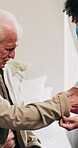 Dressing, help and nurse with old man in retirement home for assisted living or elderly care. Assistance, getting ready or sleeve with caregiver and senior patient in bedroom for aid or service