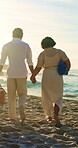 Couple, holding hands and travel with picnic basket at beach, love and summer adventure with partner. Outdoor, people and walk with spouse on coastal vacation, back and marriage commitment in nature
