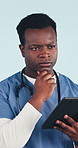 Nurse, man and thinking in studio with tablet, serious contemplation or research for patient care. Medical worker, black person and tech for problem solving, healthcare or decision on blue background