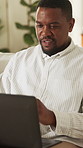 Remote work, reading or black man in home with laptop, proofreading or novel edit in creative process. WFH, writer or author with tech, manuscript review or chapter planning in story development.
