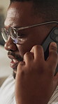 Black man, chat and phone call in home for communication, relax and social connection on weekend. Male person, happy and mobile conversation in living room for gossip, news and story in house