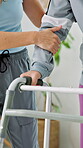 Physical therapy, hands and patient with walker in clinic, healthcare and support for rehabilitation. Physiotherapist, help and person with disability, balance and walking with assistance or wellness