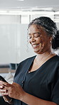 Happy, woman and typing in office with phone, social media and thinking for text message on break. Coworking, mature person and smile in business with tech, mobile chat and idea for email response.