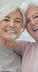 Face, friends and old women with hug for care, laughing and bonding together at home with flare. Retirement, happy people and embrace with love, funny joke and trust with support for connection