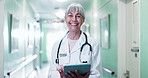 Happy, face and doctor in hospital on tablet for medical career, wellness and telehealth support. Hallway, healthcare and portrait of mature woman with tech, report and research for clinic service