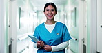 Hospital, face and nurse on tablet in hallway for medical career, wellness and schedule at clinic. Happy, healthcare and portrait of woman with smile, pride and digital tech for telehealth service