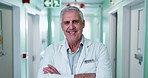 Happy, face and doctor in hospital hallway for medical career, wellness and health support. Crossed arms, healthcare and portrait of mature man with confidence, pride and smile for friendly service