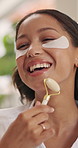 Beauty, roller and woman with eye mask in home for skincare routine, facial massage and health. Morning, laugh and person talking with rose tool for smooth skin, circulation and cosmetic benefits