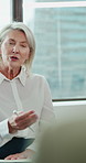 Therapy, office and business woman in workshop for mental health, wellbeing and counseling. Talking, team and mature person in support group for help, session or workplace wellness for stress relief