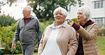 Walking, outdoor and senior people with positive attitude for bonding, connection or relax on weekend. Happy, holiday and group of elderly friends in nature for calm, good mood or peace in backyard.