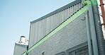 Outdoor, exterior and manufacturing warehouse for supply chain, storage facility or depot operations. Low angle, building and factory roof for logistics, industrial company or wholesale distribution.