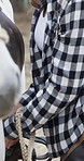 Hands, cowgirl and horse preparation on farm with saddle fitting, rider safety or riding routine. Equestrian, woman and getting ready for equine hobby, protection gear or adjust tack for animal care