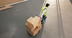 Man, boxes and trolley at depot for logistics, fulfillment and supply chain for stock delivery. Above person, walking or cardboard at warehouse with shipping, dispatch and cargo for distribution