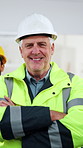 Face, man and engineer with construction team, development and leadership in building. Arms crossed, happy person and mature project manager with collaboration, authority and confidence at site