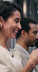 Woman, typing and waiting for interview with laugh, funny job ad and social media for stress relief. Line, mature person and happy in office for recruitment, online meme or candidate search for work.