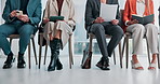 Legs, business and people in waiting room for job interview, application and resume for hiring. Feet, candidates and documents in workplace with tech, review cv and recruitment process for onboarding