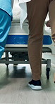 Legs, people and rush in hospital with stretcher, admission and emergency for urgent surgery. Feet, doctor or nurse hurry in lobby with gurney, critical care and operation room for healthcare service