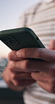 Typing, message and hands with phone, city and communication with contact on social media or online. Texting, outdoor and person with mobile, internet search and networking with tech and connection