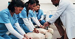 Healthcare, team or dummy in training for cpr, compression technique or residency practical. Man, physician or resident doctors with mannequin, life saving procedure or clinic simulation in first aid