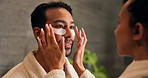 Skincare, couple and eye mask in bathroom, help and laugh with facial treatment for vitamin c. Man, woman and apply patches for dermatology with beauty care, funny and collagen with love at home