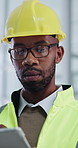 Black man, engineer and reading in office with tablet, research and schedule for architecture. Thinking, person and review in workplace with tech, inspection and compliance for building development