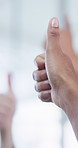 People, hands or meeting with thumbs up in office for business success or positive feedback together. Group, employees or colleagues with like emoji, yes sign or OK for team approval in workplace
