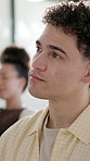 Audience, man and serious with listen for workshop, business development and employee education. Insight, person and taking notes in crowd for career growth, speech agreement and workplace learning