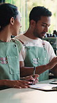 Clipboard, management and people with writing in cafe together for budget or planning. Tech, finance review and chat with store owner team in coffee shop or restaurant for small business strategy