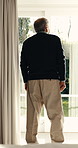 Thinking, back and old man at window with nostalgia, daydreaming or flashback with calm mindset. Chill, insight or elderly person with reflection, retirement memory or peaceful perspective in house.